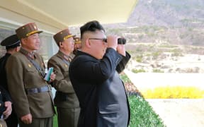 This undated picture released from North Korea's official Korean Central News Agency (KCNA) on April 14, 2017 shows North Korean leader Kim Jong-Un (C) inspecting the "Dropping and Target-striking Contest of KPA Special Operation Forces - 2017" at an undisclosed location in North Korea.