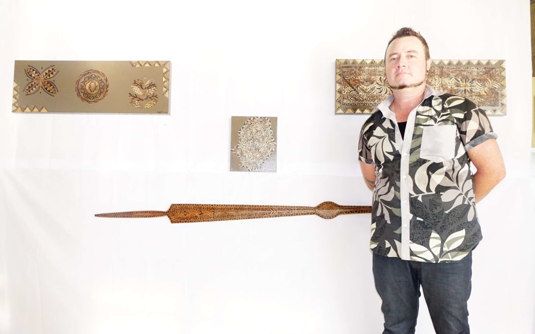 "Niue does actually have some pretty nice designs," said artist Kenneth Green. Here, he stands next to some of his works.