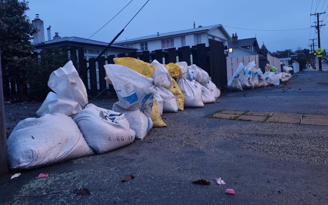Floodwaters have receded in some parts of Gore, but sandbags remain in place to protect properties. Ardwick Street has reopened where emergency services were busy pumping water and adding sandbags yesterday.