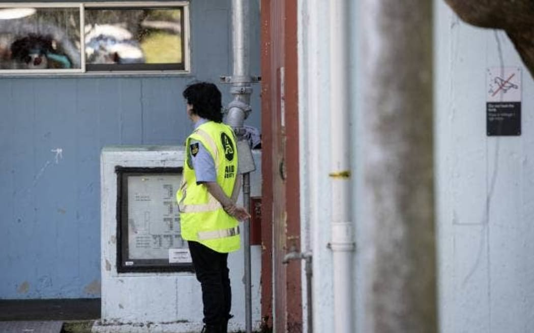 A security guard is stationed at the Pukehinau Flats to help residents while the lift is inoperable.