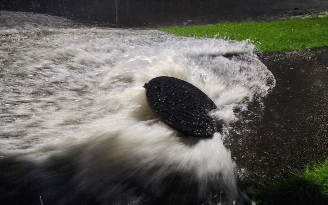 A manhole on Meola Road in Sandringham struggles to keep up with floodwaters on 1 February.
