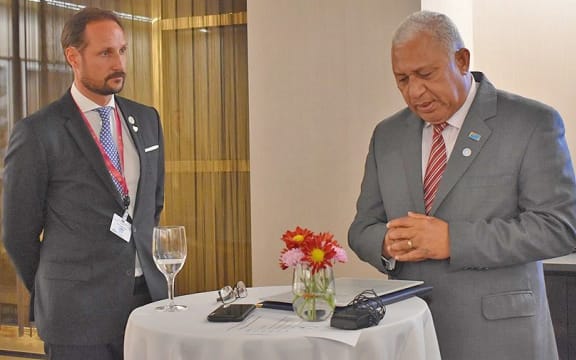 Crown Prince of Norway Haakon Magnus watching Frank Bainimarama launching the fund.