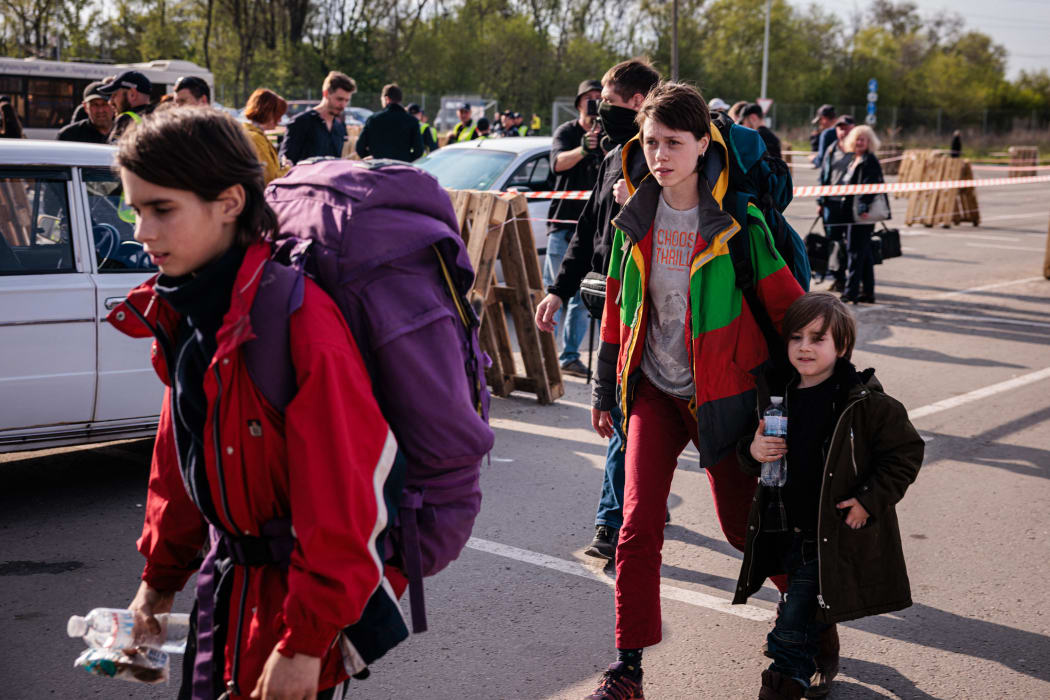 A family evacuated from Mariupol's Azovstal plant arrive at a registration and processing area for internally displaced people in Zaporizhzhia on 3 May. The UN said 101 refugees had been evacuated with the Red Cross by Tuesday.