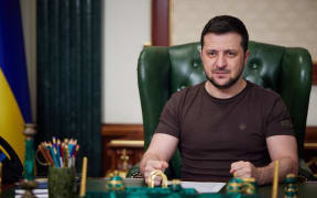 In this handout picture taken and released by the Ukrainian Presidency Press Office early on March 14, 2022, Ukrainian President Volodymyr Zelensky delivers a video address in Kyiv. -