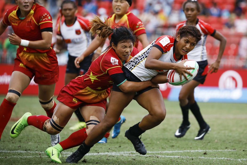 PNG's Helen Abau is tackled by China's Wang YueYue in the 11th place playoff.
