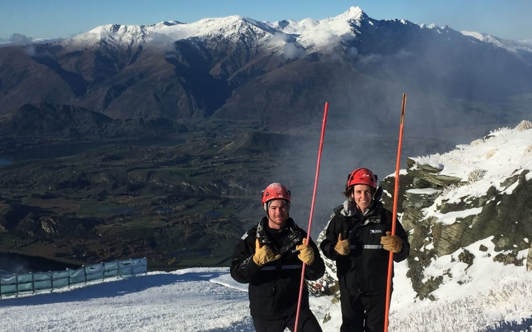 Coronet peak staff members Jake Reilly and Lucy Ruck help with snowmaking duties.
