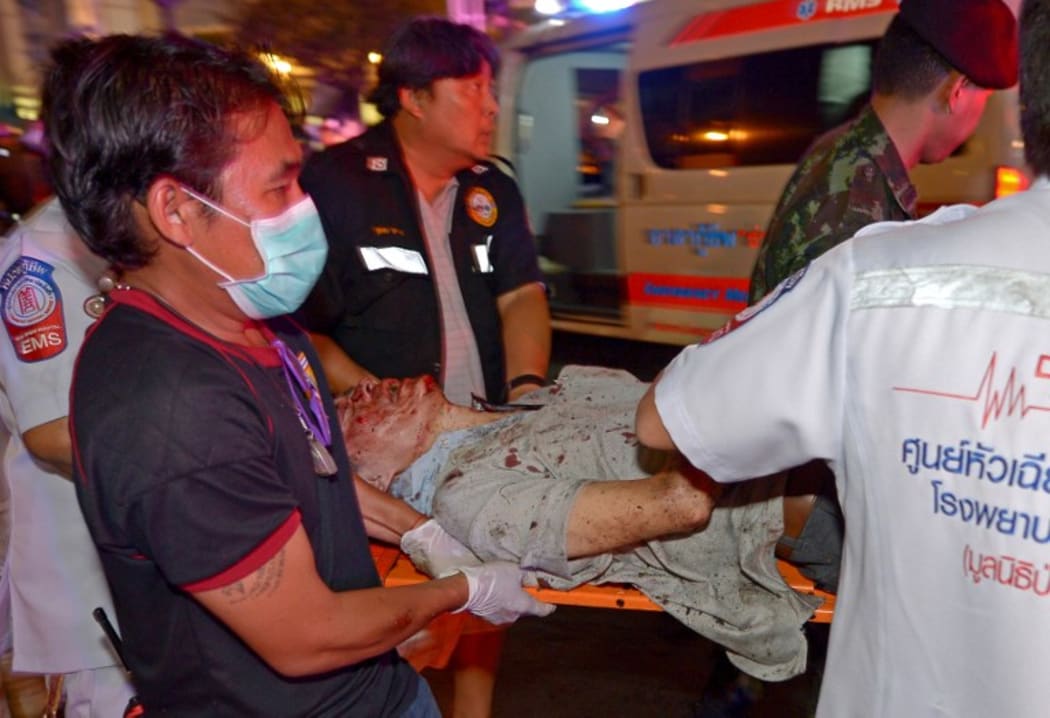 Rescue workers move a person injured in the blast.