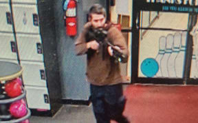 This handout image released on October 25, 2023 by the Androscoggin County Sheriff's Office via Facebook shows a photo of the armed suspect in a shooting as law enforcement in Androscoggin County investigate 'two active shooter events' in Lewiston, Maine. The suspect is still at large, according to the Androscoggin County Sheriff's Office.