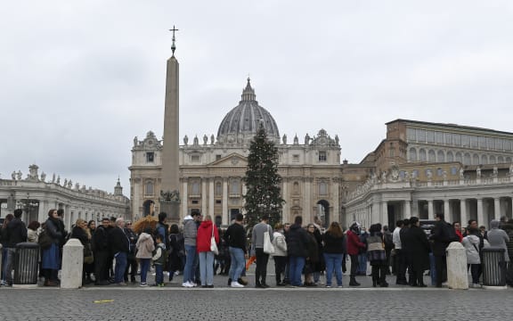 People wait in a line to enter Saint Peter's Basilica at the Vatican where late Pope Benedict 16 is being laid in state at The Vatican, Monday, Jan. 2, 2023. Benedict XVI, the German theologian who will be remembered as the first pope in 600 years to resign, has died, the Vatican announced Saturday. He was 95.