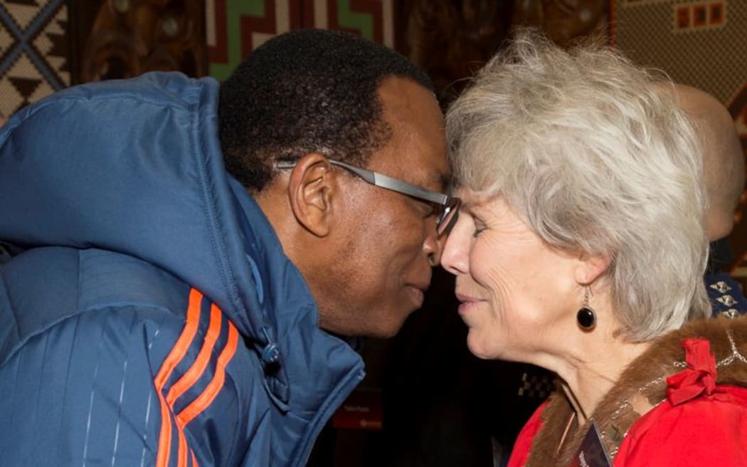 Sheryl Mai greets a member of the USA entourage.