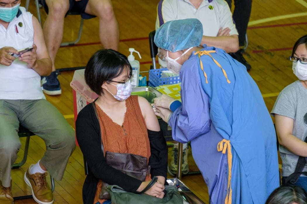 A person seen getting her first dose of Taiwanese home grown COVID-19 vaccine developed by Medigen Vaccine Biologics Corp. in Taipei , Taiwan, 23 June 2021.