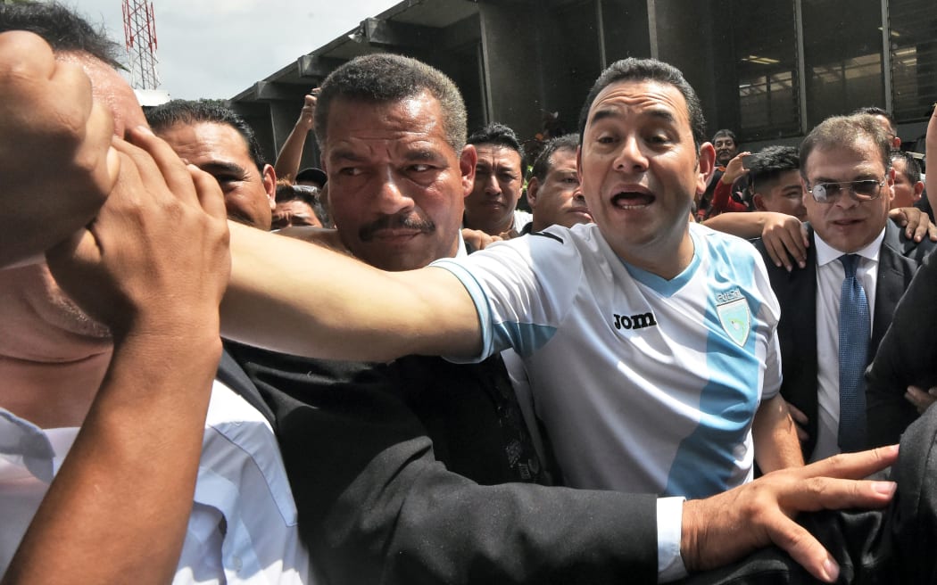 Guatemalan presidential candidate Jimmy Morales greets supporters before voting in Mixco, near Guatemala City.