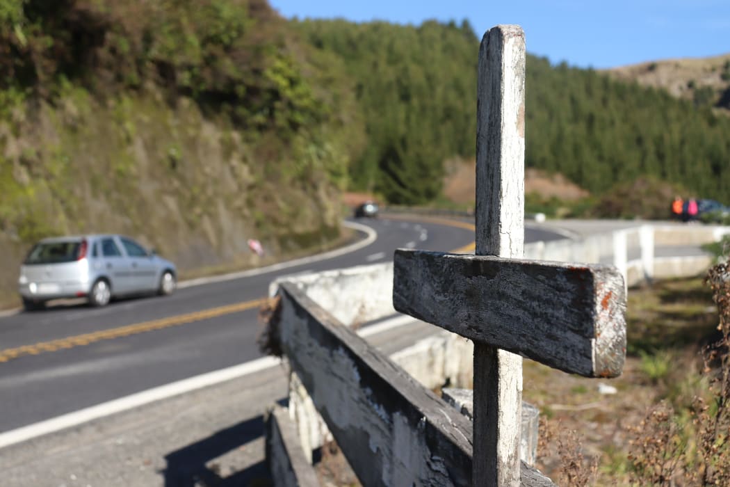 A cross stands on State Highway 5, marking the spot of a fatal crash on the road