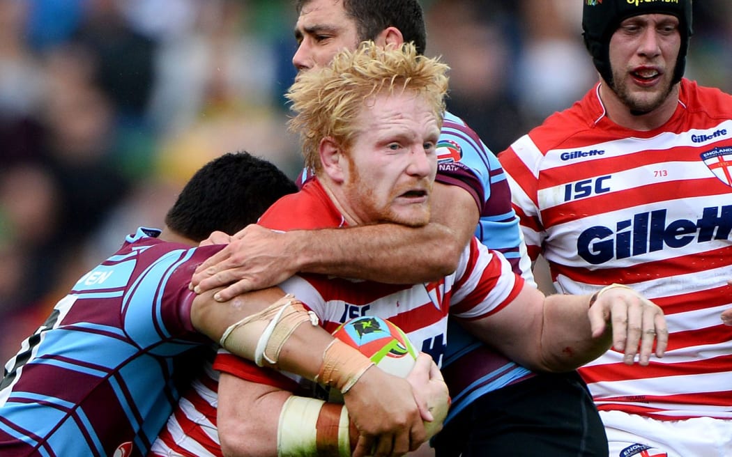 England's James Graham is tackled by Australian opponents. Four Nations. 2014.