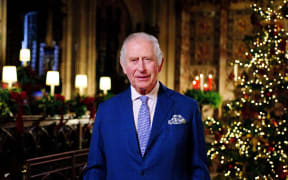 A picture released on December 23, 2022 shows Britain's King Charles III posing for a photograph during the recording his first annual Christmas Day message, in the Quire of St George's Chapel at Windsor Castle, west of London on December 13, 2022. (Photo by Victoria Jones / POOL / AFP) / EMBARGOED: Not for publication in any territory before 2200 GMT TIME.
