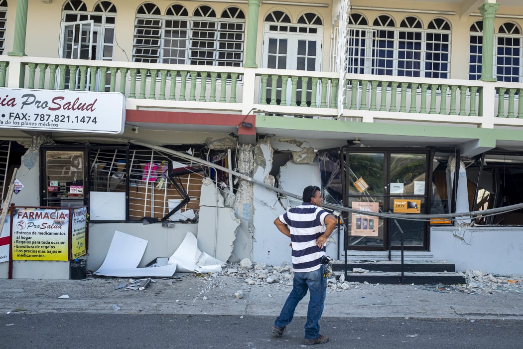 A man surveys a collapsed businesses after an earthquake hit Guanica, Puerto Rico on January 8, 2020.
