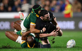 All Black Will Jordan is tackled and spills the ball during the Rugby Championship match between New Zealand and South Africa at Mt Smart Stadium.