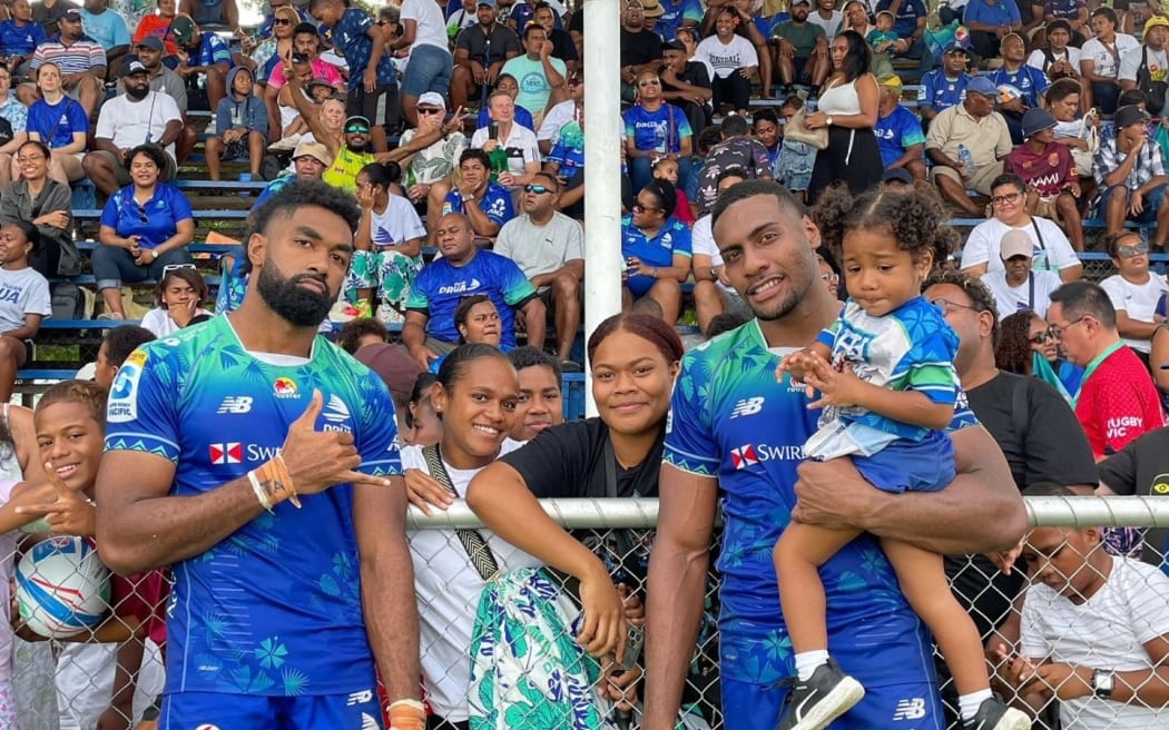 Drua players Etonia Waqa (left) and Mesake Vocevoce celebrate their win over the Rebels with fans in Lautoka on Saturday.