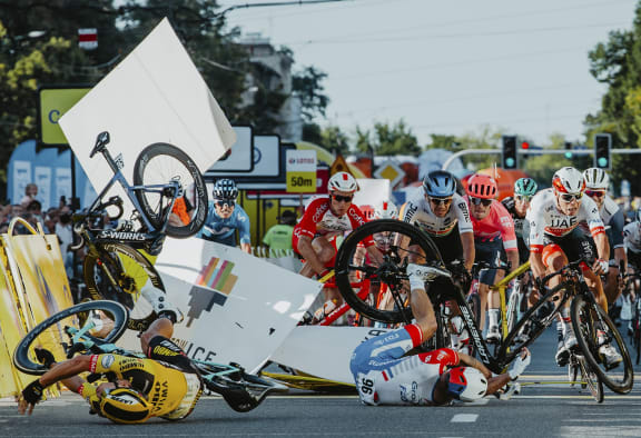 Dutch cyclist Fabio Jakobsen's bicycle (behind,L) flies through the air as he collides with compatriot Dylan Groenewegen (on the ground ,L) during the opening stage of the Tour of Poland race in Katowice , southern Poland on August 5, 2020.