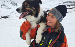 Echo rides on Lisa Jaggi's shoulders or runs between her skis when she's heading to a search site