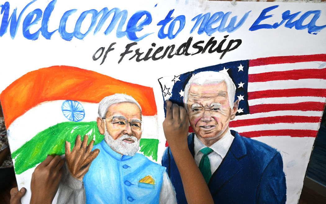 Students give final touches to a painting of India's Prime Minister Narendra Modi and US President Joe Biden, at an art school in Mumbai on September 7, 2023, ahead of the two-day G20 summit in New Delhi.