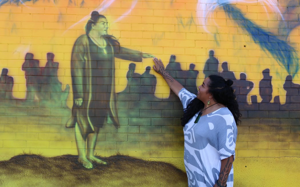 Amiria Puia-Taylor reaches out to the image of her on the mural.