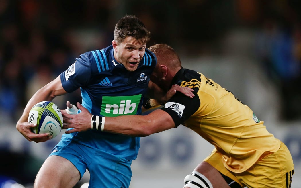 Matt Duffie of the Blues fends against Brad Shields of the Hurricane