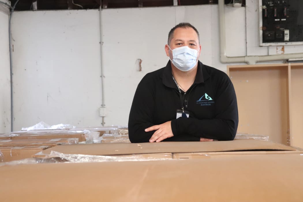 Te Kupenga Hauora Ahuriri chief executive Nathan Harrington among the many boxes on site of rapid antigen tests.