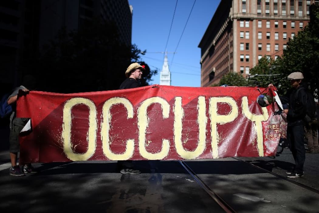 Occupy Wall Street protestors hold a large banner during a demonstration in San Francisco in 2012.