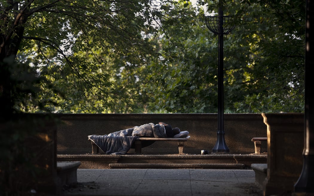 A person sleeps in Meridian Hill Park on 25 July, 2025 in Washington DC.