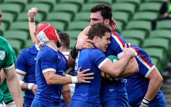 France's rugby captain Charles Ollivon celebrates after scoring a try.