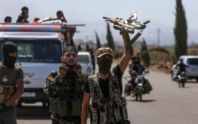 Fighters from Bedouin tribes gather in the al-Mazraa village in Syria's southern Sweida governorate, as clashes with Druze gunmen continue on 18 July, 2025.