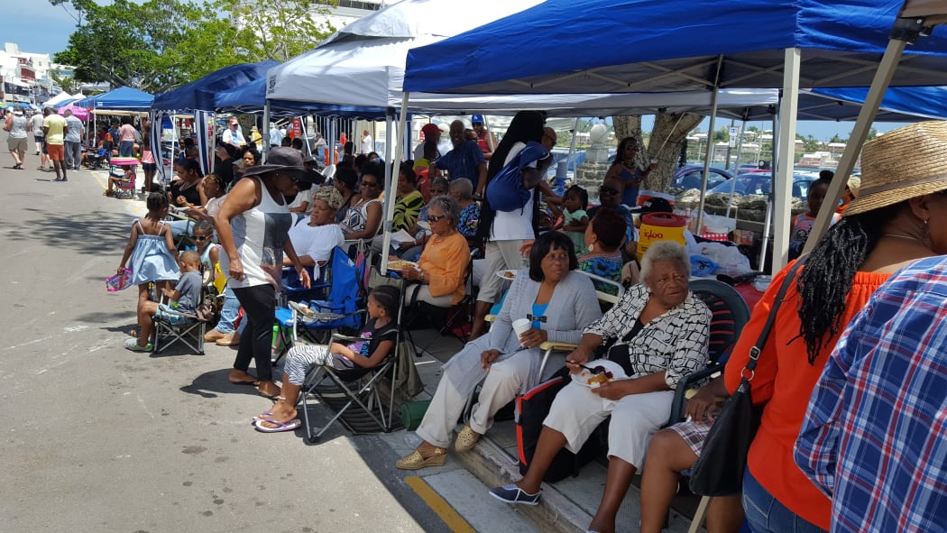 Bermudan's stake out prime spots along the downtown footpath days in advance of the national holiday, setting up big family kitchens
