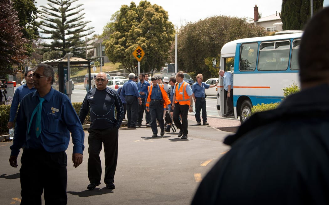 Bus drivers arriving at their stop work meeting at midday today.