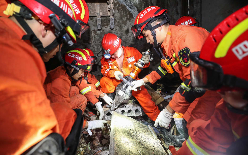 Rescuers search for trapped people in Shuanghe Town in Changning County of Yibin City, southwest China's Sichuan Province, June 18, 2019.