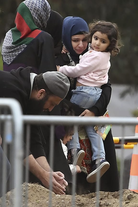 Relatives of Syed Jahandad Ali, victim of New Zealand's mosque attacks, at his grave after burial at the Memorial Park cemetery in Christchurch on March 22, 2019.