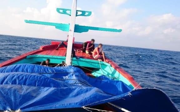 The report says this photo was taken by an asylum seeker and shows a two-deck boat from Indonesia before it was intercepted by Australia in May 2015.