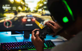 Teenager playing video games online.