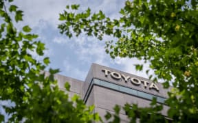 Signage is pictured outside the headquarters of Japanese automaker Toyota in Tokyo on May 8, 2024. (Photo by Yuichi YAMAZAKI / AFP)