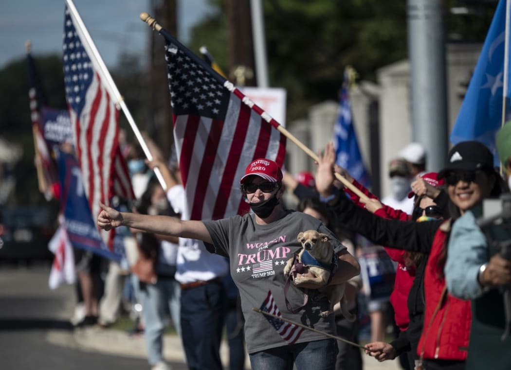 Supporters of US President Donald Trump gather outside of Walter Reed National Military Medical Center to show their support, on October 3, 2020, in Bethesda, Maryland.