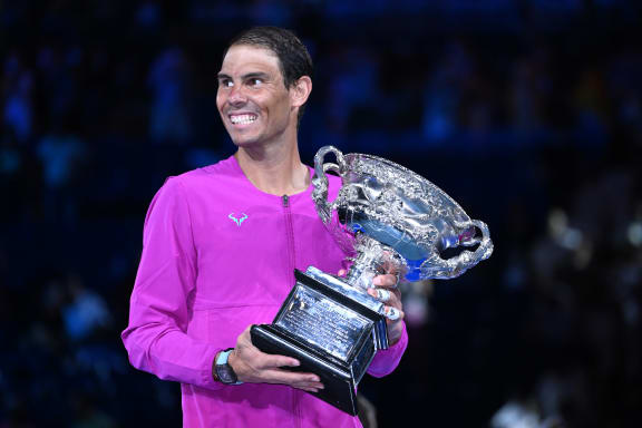 Rafael Nadal of Spain holds the Norman Brookes Challenge Cup after winning the men's singles final against Daniil Medveded of Russia at the 2022 Australian Open.