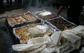 A hāngi is prepared for tourists at Mitai Maori Village, Rotorua.