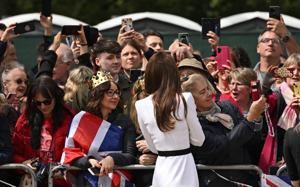 Catherine, Princess of Wales speaks with well-wishers on The Mall near Buckingham Palace in central London, on 5 May, 2023, ahead of the coronation weekend.