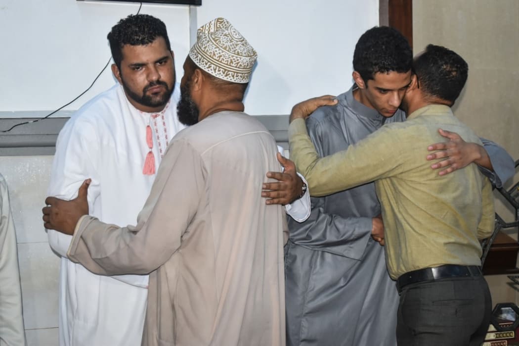 A brother (2nd R) and an uncle (L) of Yared Tessema Getachew, 29-year old Ethiopian Kenyan national pilot of ill-fated Ethiopian Airlines, are comforted after their prayer at Baluchi Mosque in Mombasa, Kenya,