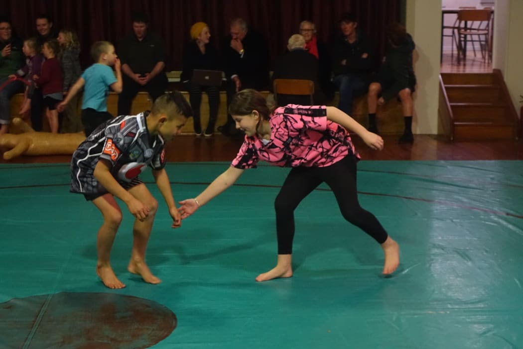 Zion Lawrence, left, takes on Ruby Murdoch in a training bout - Alton Olympic Wrestling Club