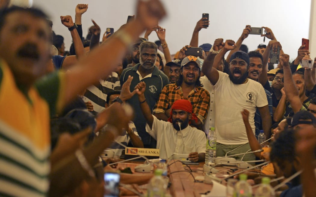 People crowd inside the Sri Lanka's presidential palace, in Colombo on July 10, 2022, a day after it was overrun by anti-government protestors. - Sri Lanka's colonial-era presidential palace has embodied state authority for more than 200 years, but on July 10 it was the island's new symbol of "people power" after its occupant fled. (Photo by Arun SANKAR / AFP)