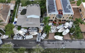 TREASURE ISLAND, FLORIDA - SEPTEMBER 28: In this aerial view, boats are piled up in front of homes after Hurricane Helene hit the area as it passed offshore on September 28, 2024 in Treasure Island, Florida. Hurricane Helene made landfall Thursday night in Florida's Big Bend with winds up to 140 mph and storm surges that killed at least 42 people in several states.   Joe Raedle/Getty Images/AFP (Photo by JOE RAEDLE / GETTY IMAGES NORTH AMERICA / Getty Images via AFP)