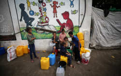 Displaced people are seen in the yard of a United Nations Relief and Works Agency for Palestine Refugees (UNRWA) school in Khan Yunis, in the southern Gaza Strip on 30 October 30, 2023, amid ongoing battles between Israel and the Palestinian Hamas movement.