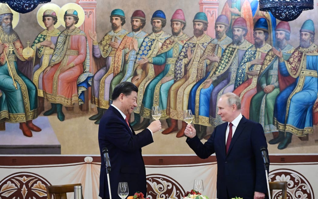 Russian President Vladimir Putin and China's President Xi Jinping make a toast during a reception following their talks at the Kremlin in Moscow on 21 March, 2023.