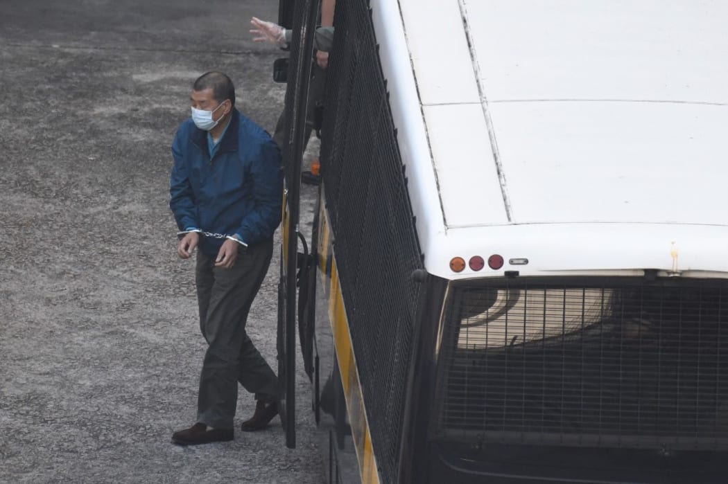 Jimmy Lai is seen handcuffed as he exits a prison van at Lai Chi Kok Reception Centre.